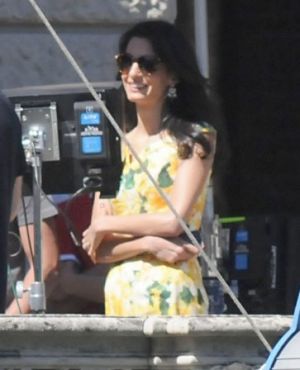 Amal Alamuddin in yellow floral dress watches George Clooney on set.jpg